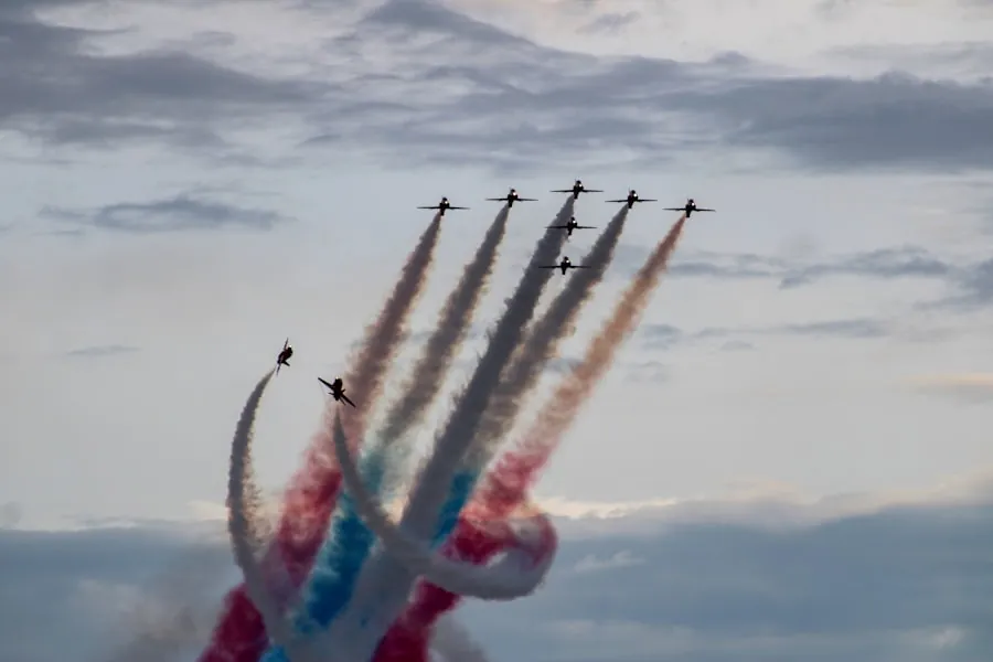 An aerobatic display team trailing red, white and blue smoke